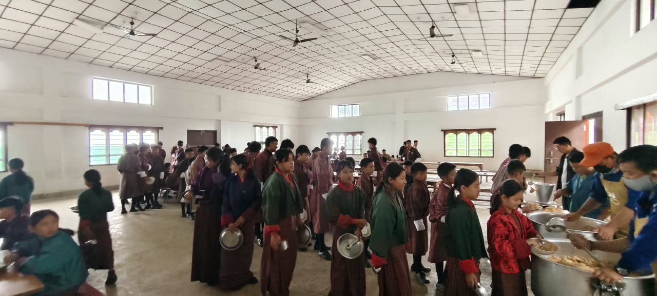 students being served food in bhutan school