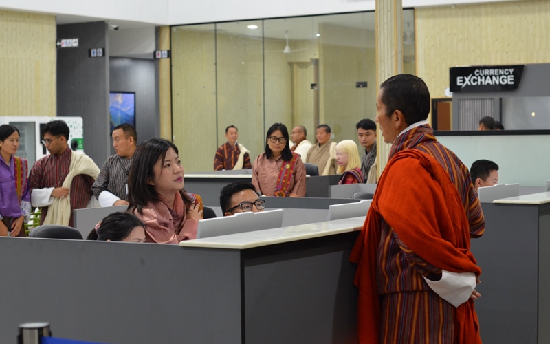 dr lotay and staff talking at gelephu airport